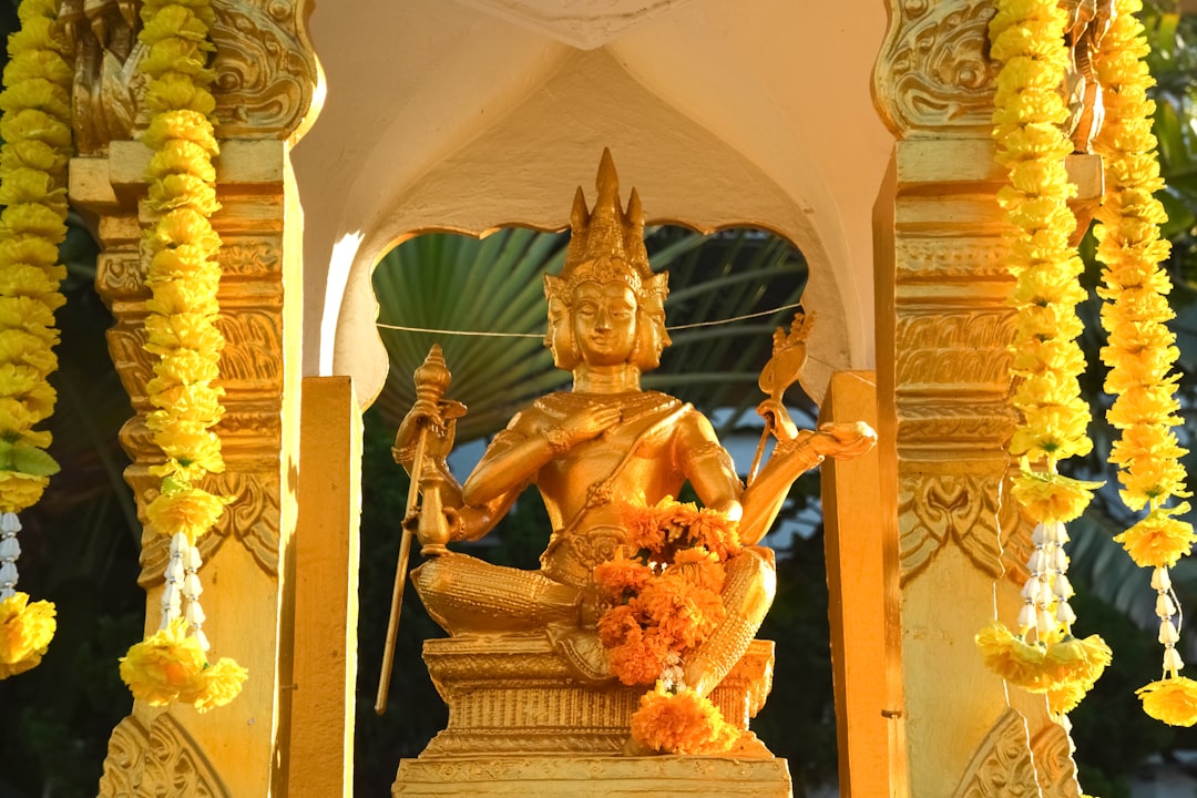 gold hindu deity statue on gold framed mirror