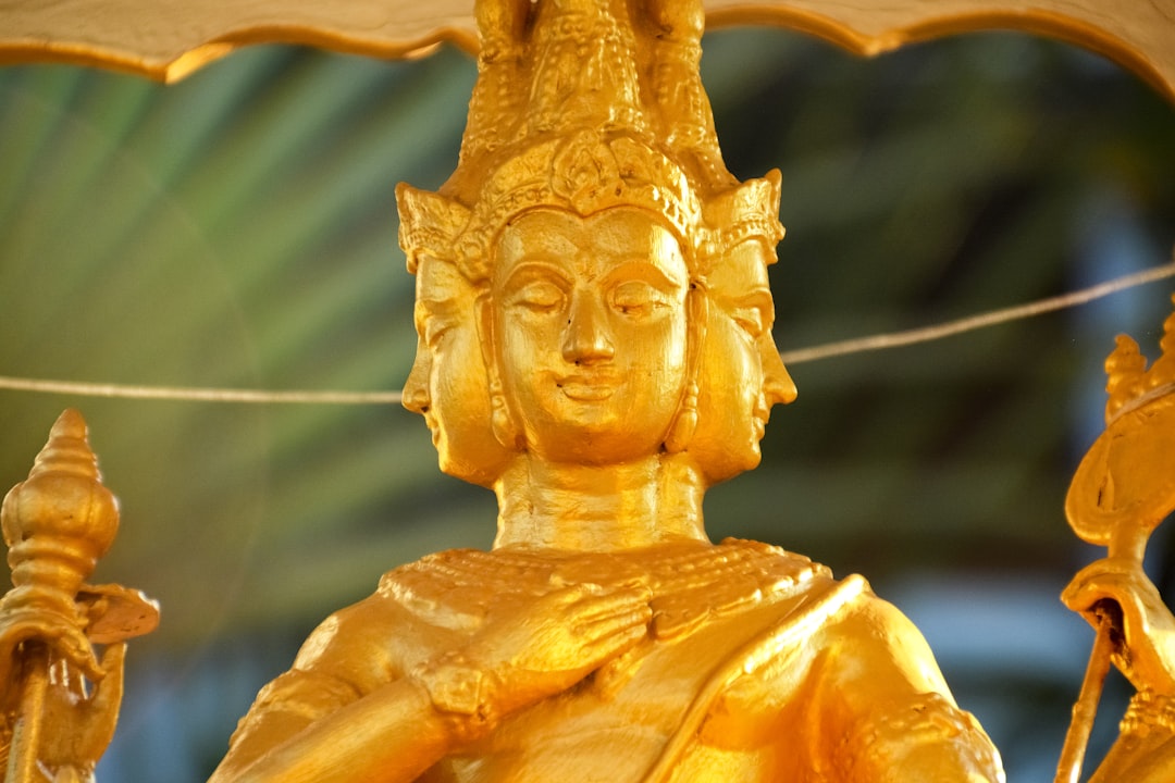 gold angel figurine in close up photography