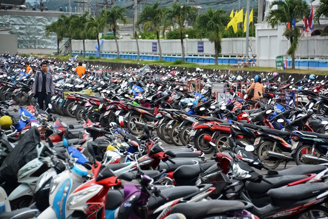 parked motorcycle on parking lot during daytime