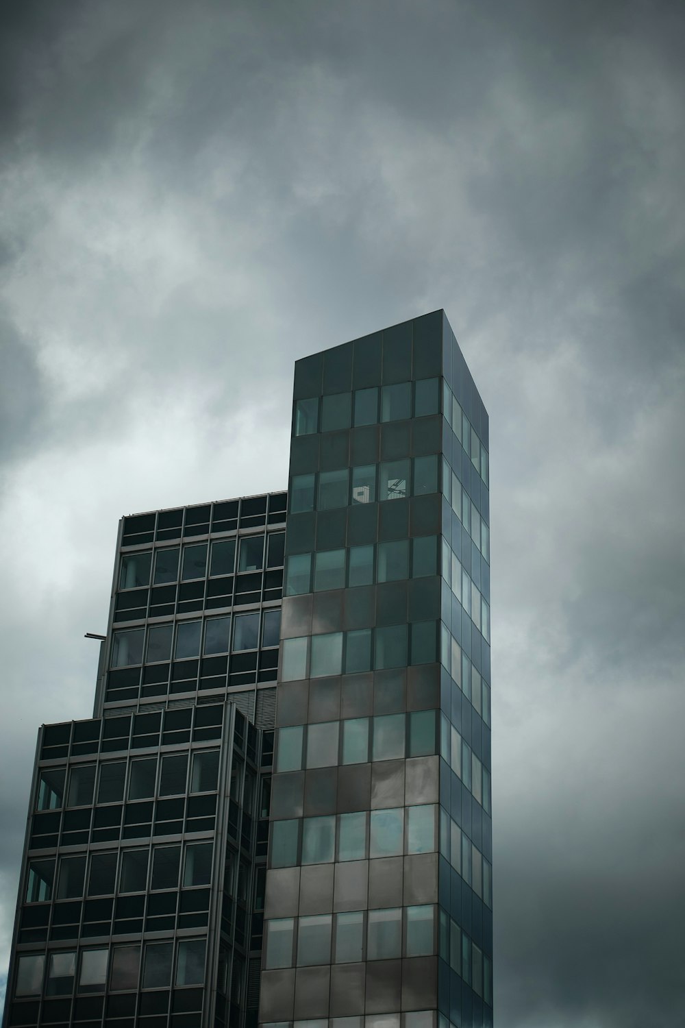 blue and white concrete building under gray clouds