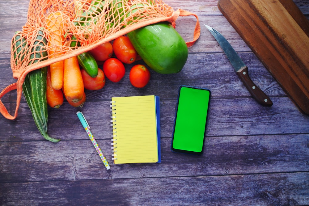 green cucumber beside green spring notebook