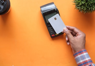 person holding black and white electronic device