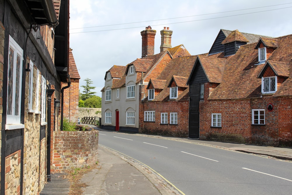 red and white concrete building beside road during daytime