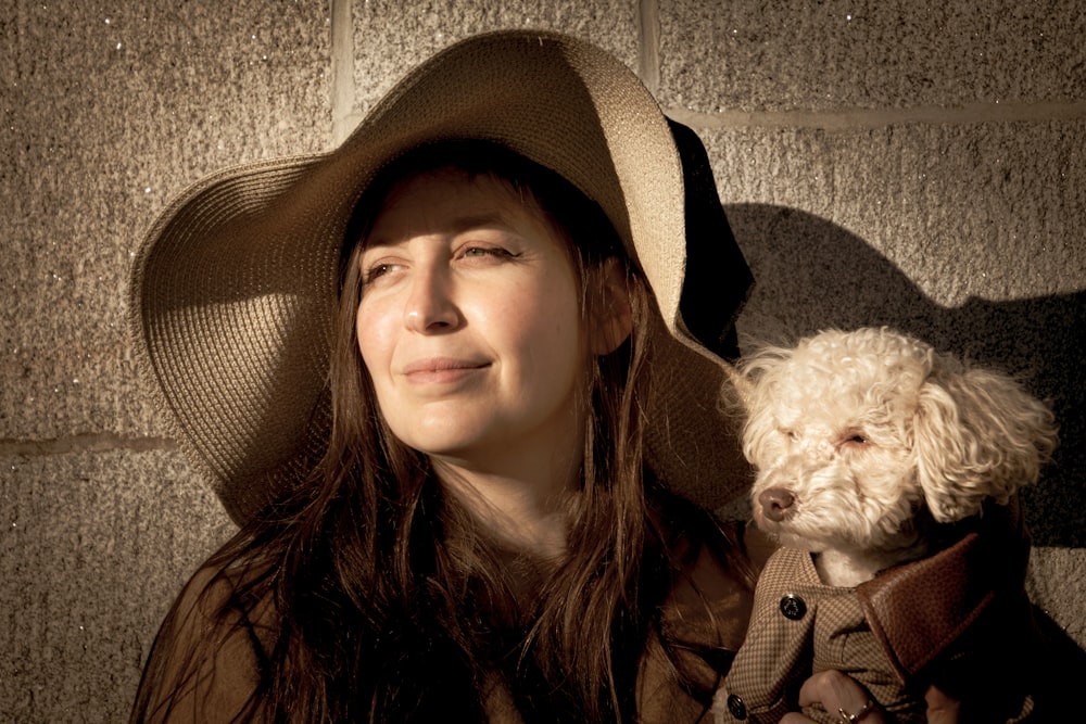 grayscale photo of woman with long coated dog