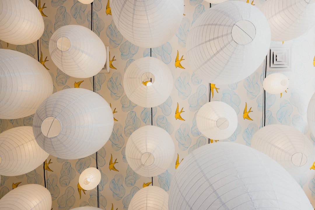 white paper lanterns hanging on ceiling