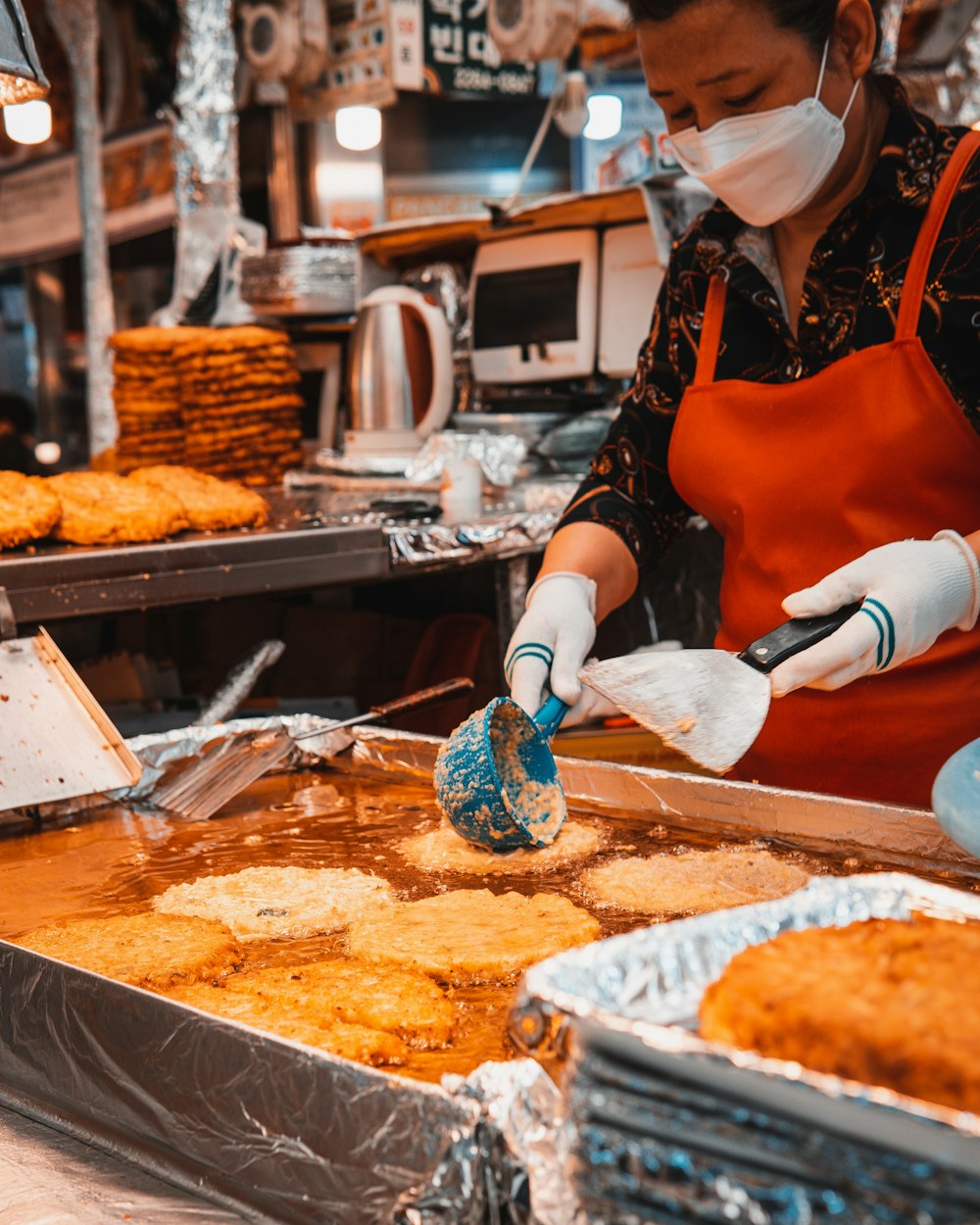 woman in red apron slicing bread