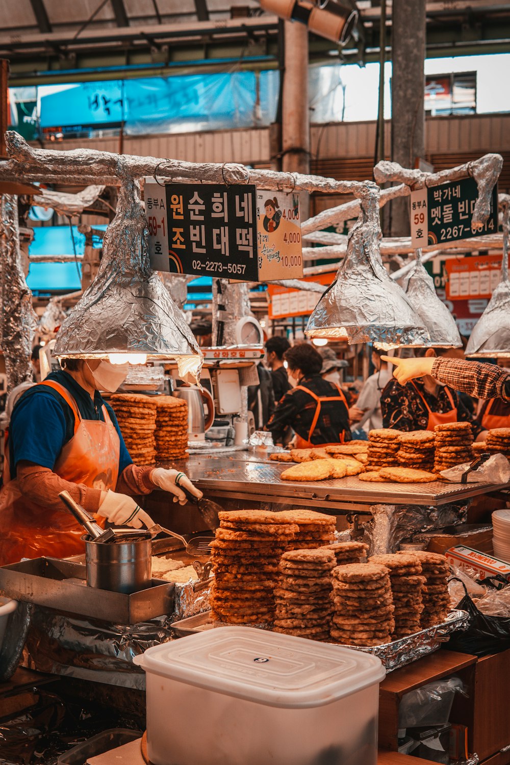 person in orange jacket holding brown woven basket