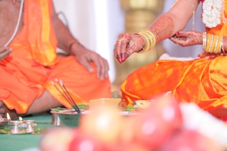 person in orange dress holding green paint brush