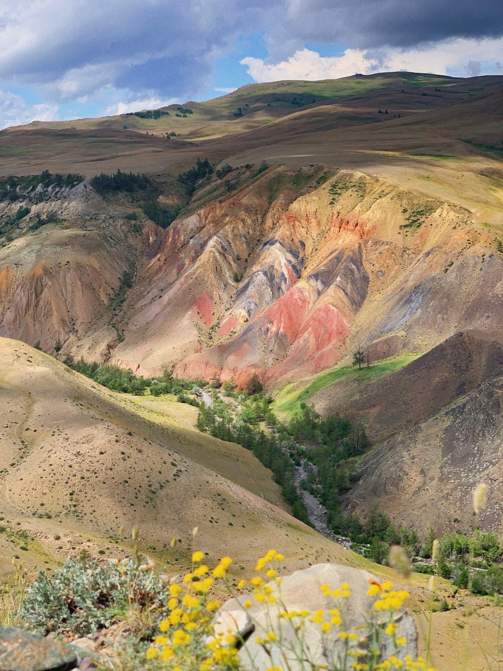 brown and green mountains under white clouds during daytime