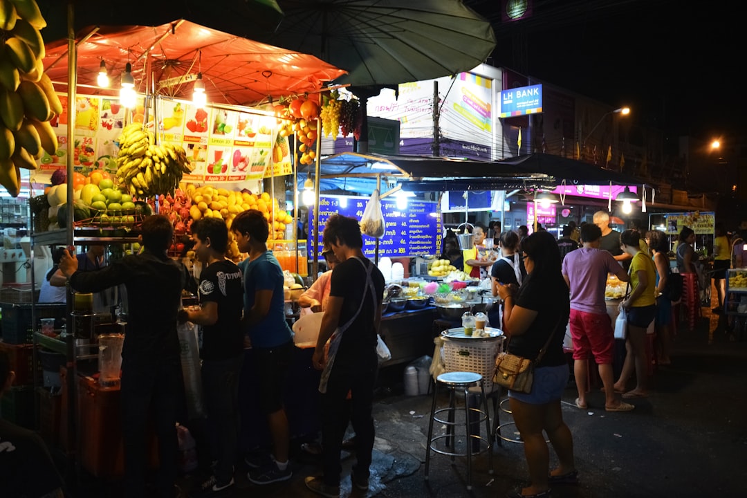 people standing in front of food stall during night time