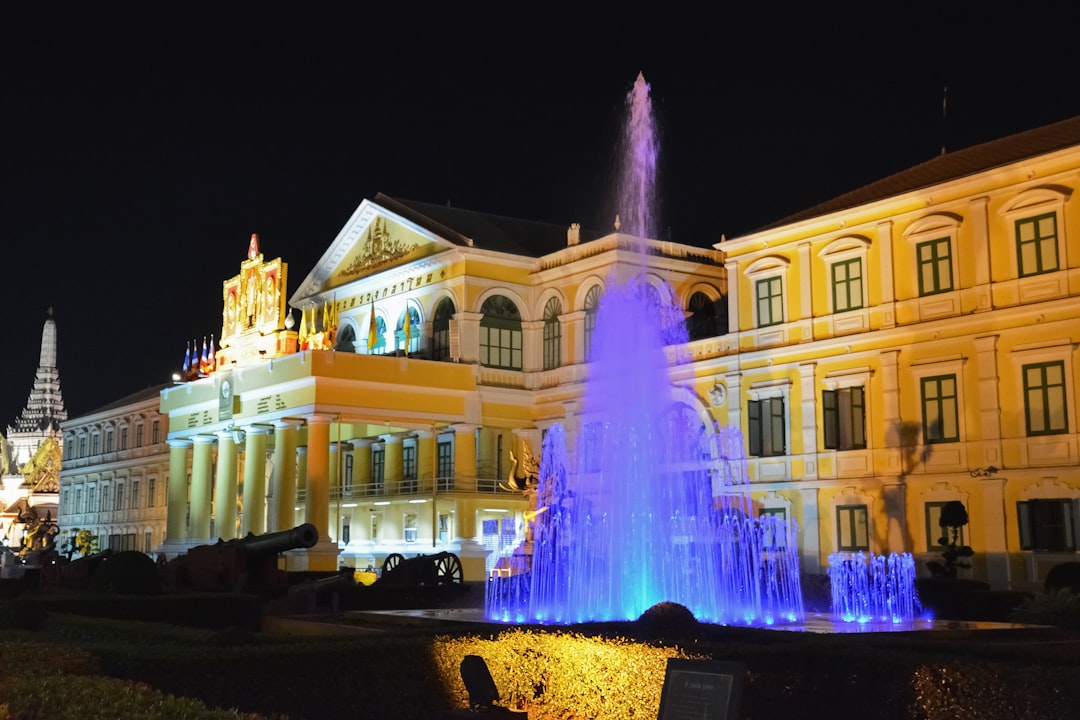 water fountain in front of white building during nighttime