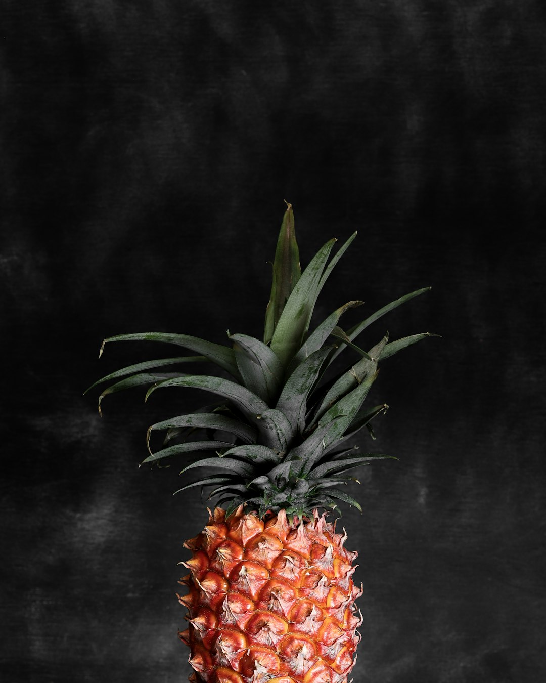 pineapple fruit on black textile