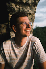 man in white crew neck shirt wearing black framed eyeglasses
