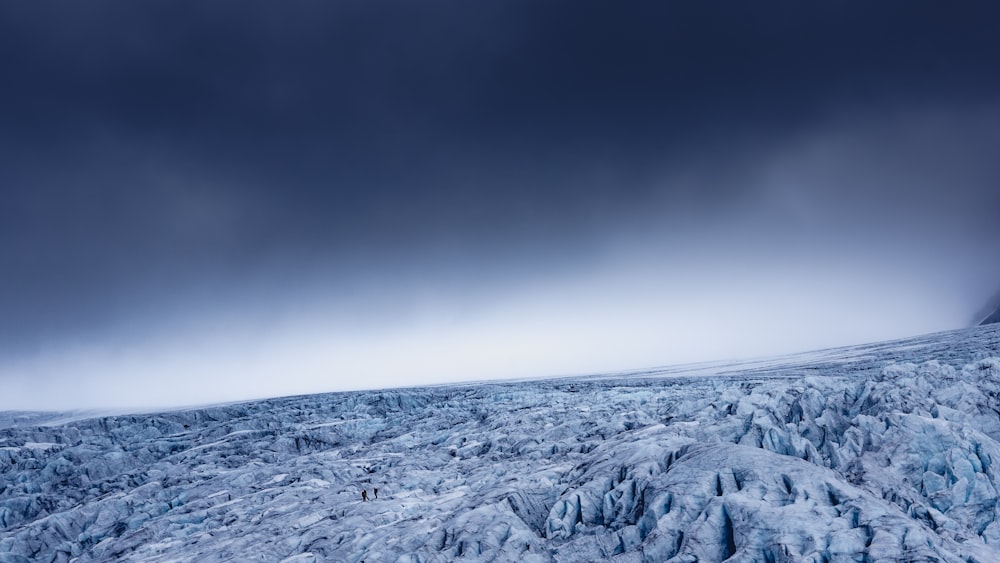 snow covered mountain under gray sky