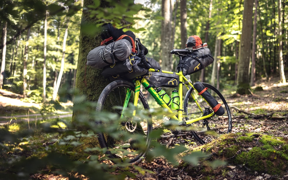 man in black jacket and black backpack riding on green bicycle