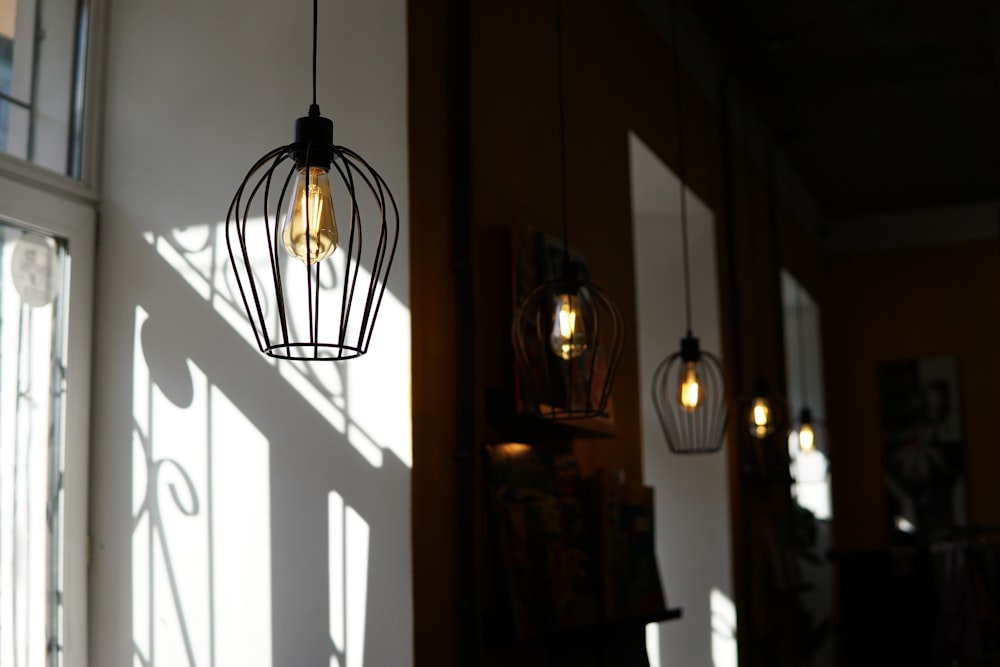 black pendant lamp turned on near brown wooden door