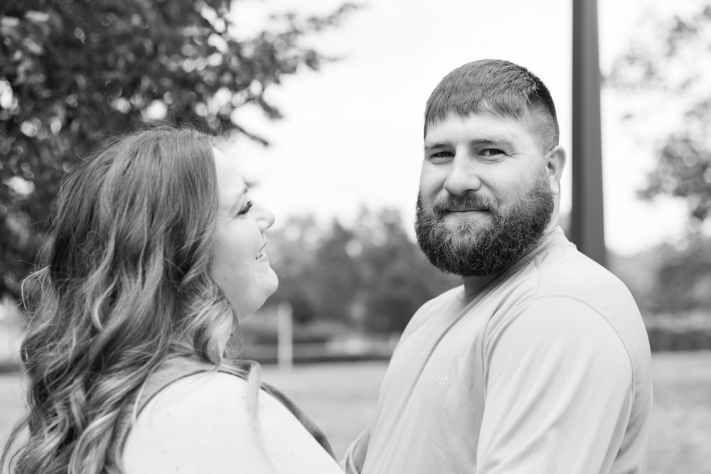 man in white crew neck shirt kissing woman in white tank top