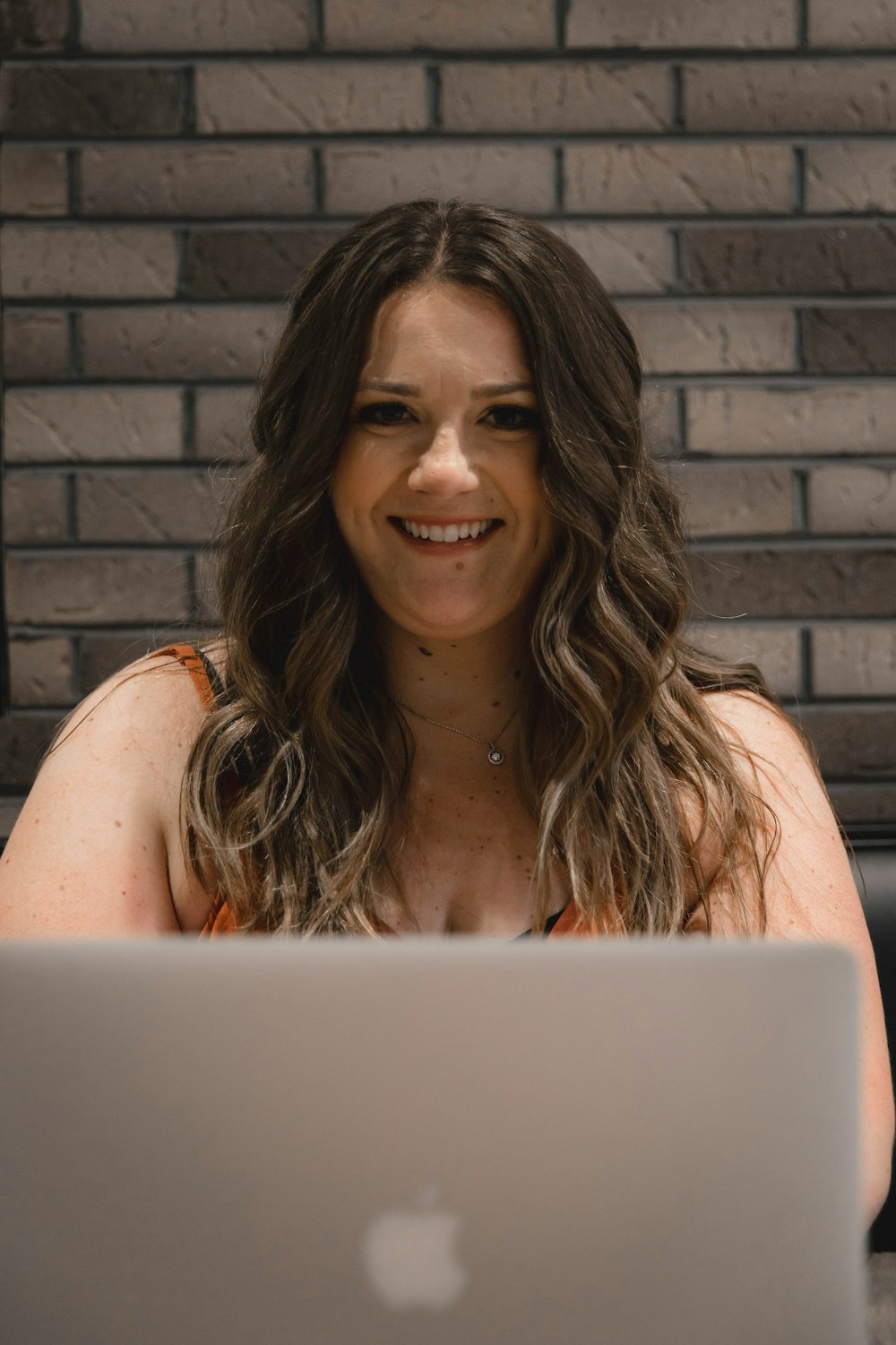 woman in white tank top smiling