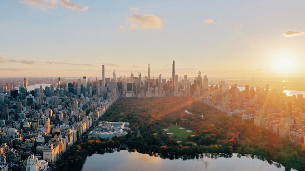 an aerial view of a city with a lake in the foreground