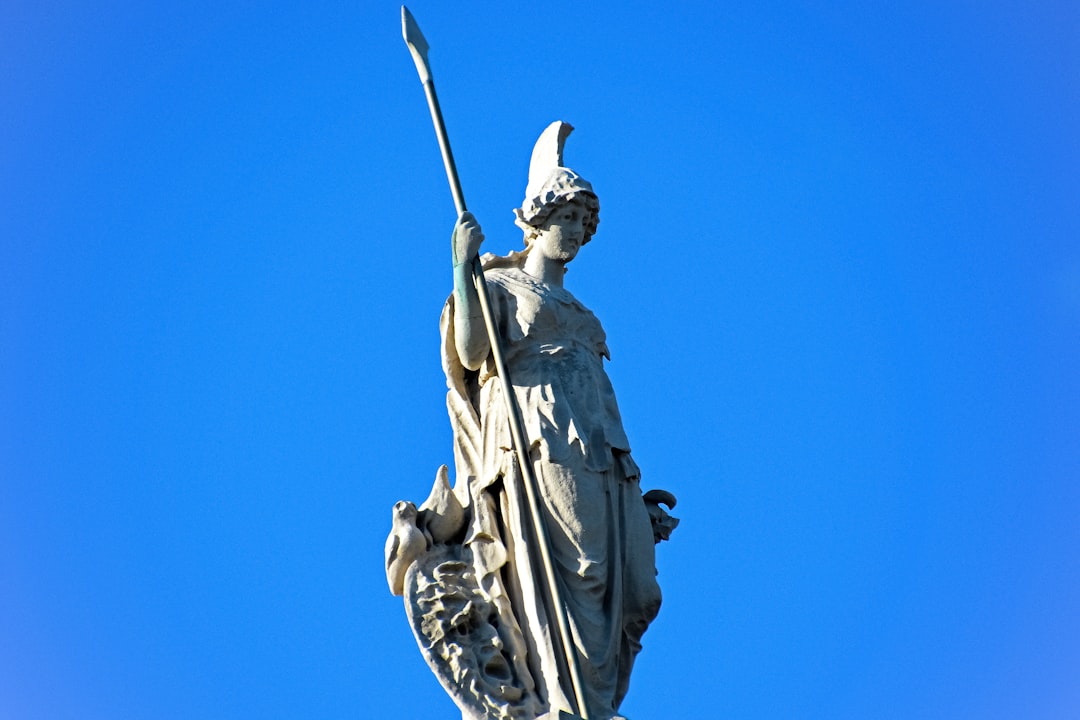 man holding a sword statue