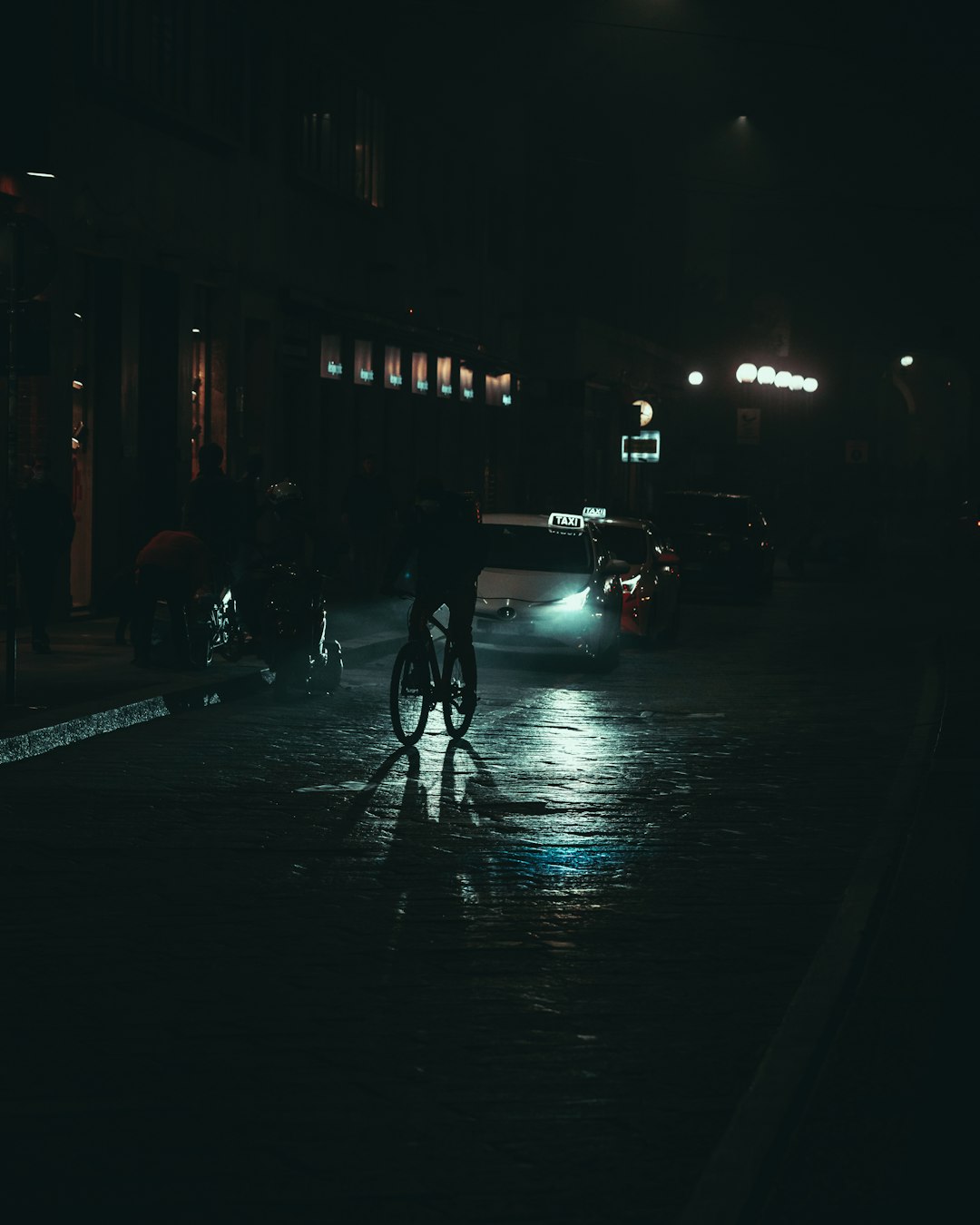 people walking on sidewalk during night time