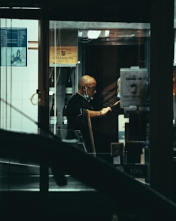 man in black jacket sitting on black chair