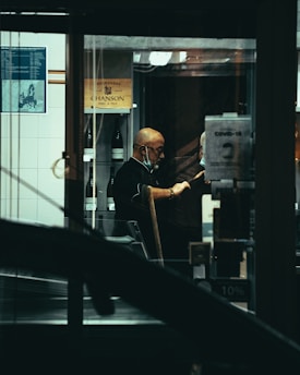 man in black jacket sitting on black chair