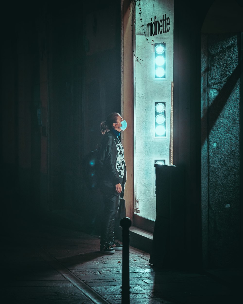 woman in black and white jacket standing on hallway