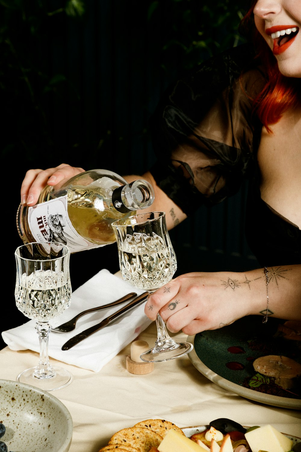 woman in black long sleeve shirt holding clear wine glass