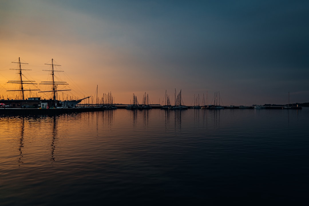 silhouette of boat on sea during sunset