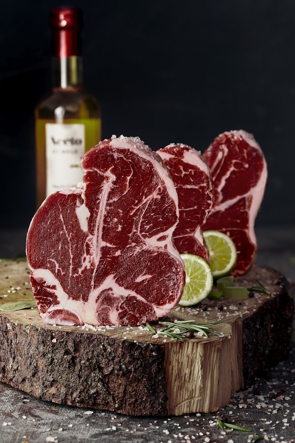 Raw meat on brown wooden chopping board