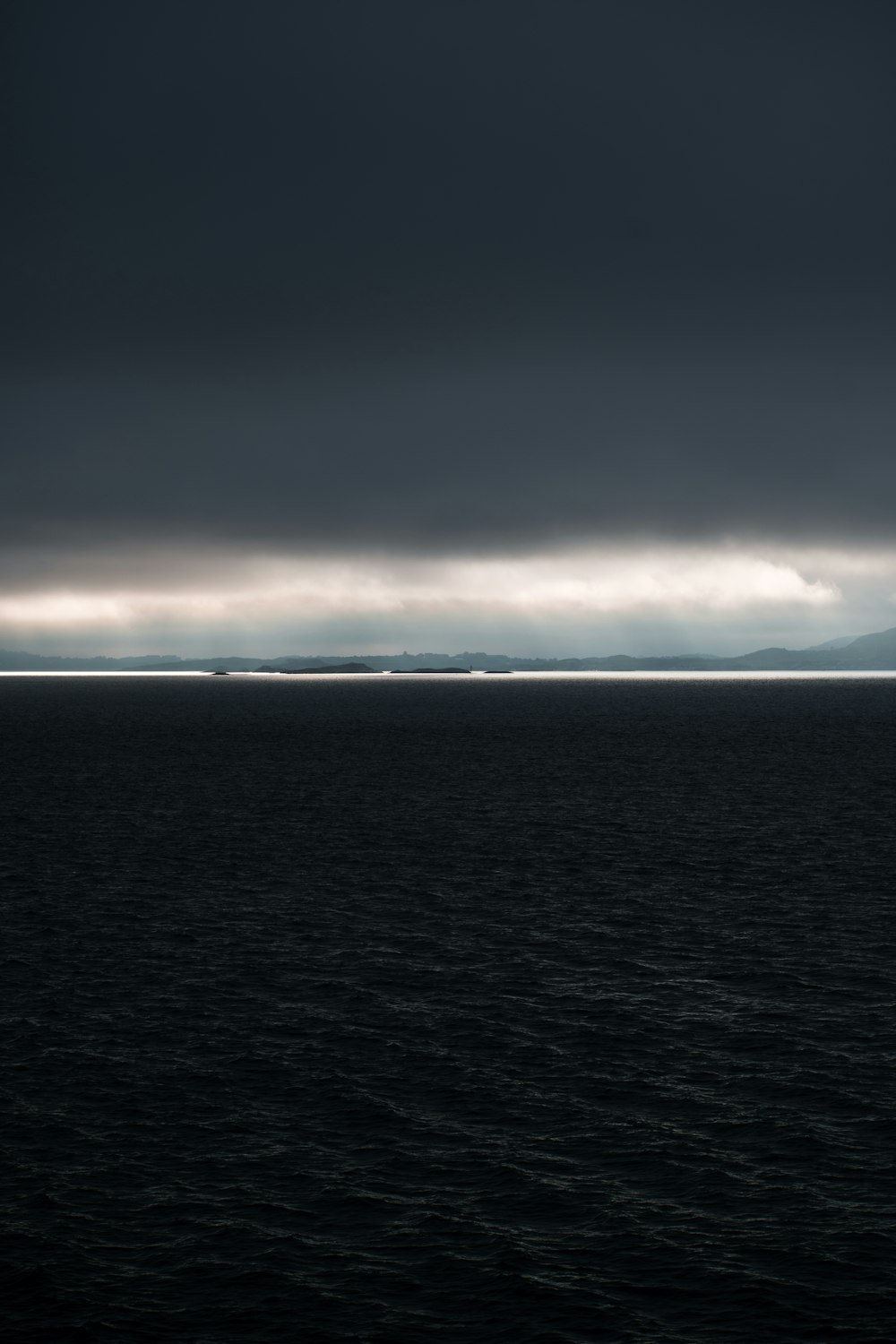 body of water under cloudy sky during daytime