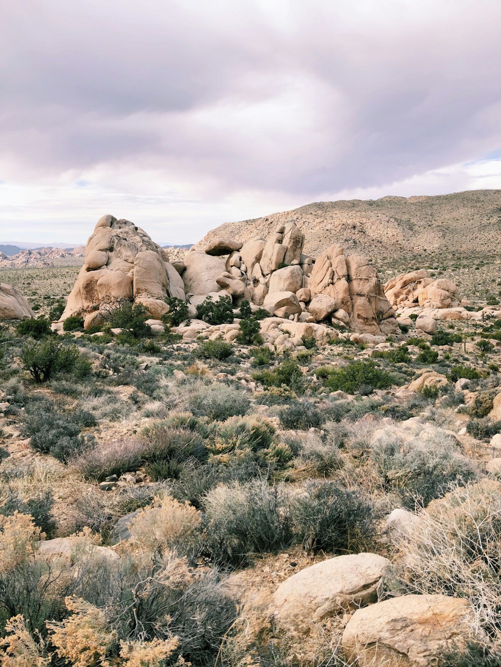 brown rock formation under white clouds during daytime