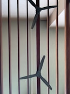 Electrician installing ceiling fans in a living room.