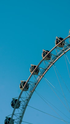 black and white ferris wheel under blue sky during daytime