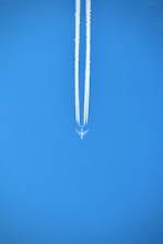 silver necklace on blue textile