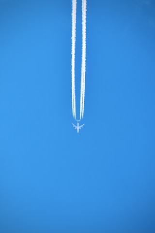 silver necklace on blue textile