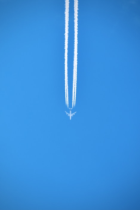 silver necklace on blue textile
