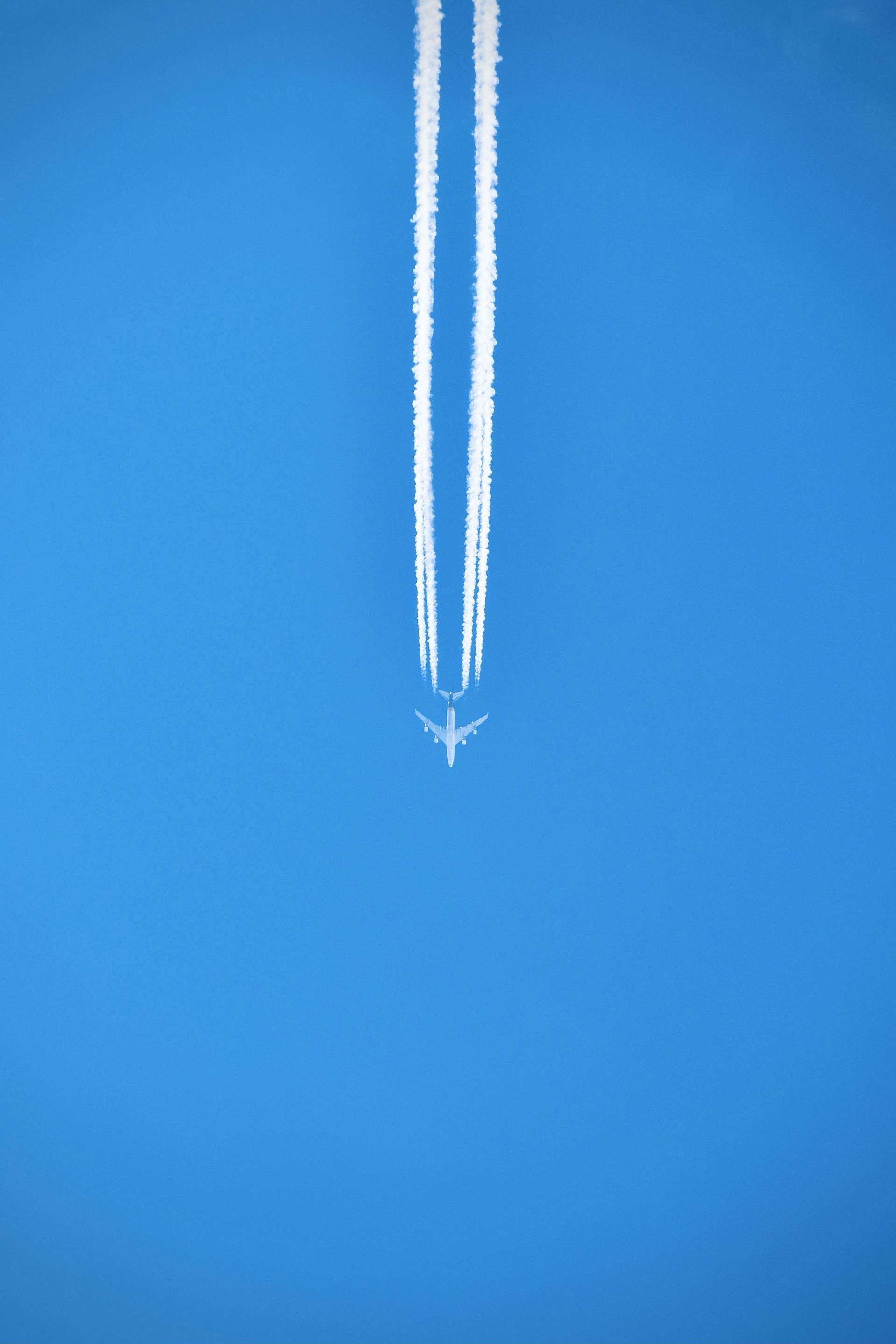 silver necklace on blue textile