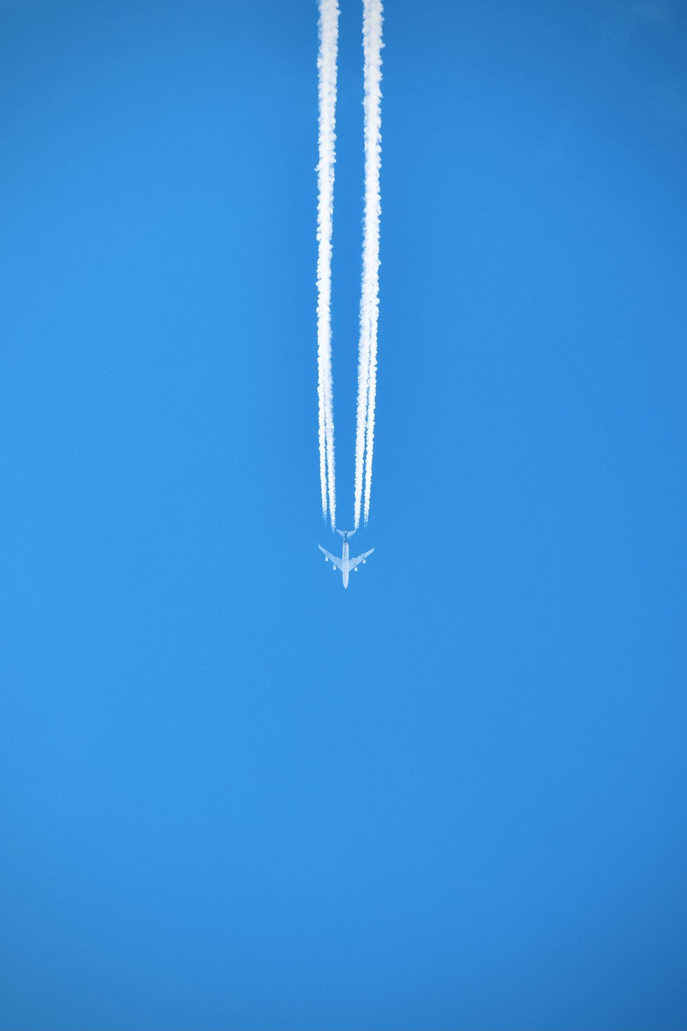 silver necklace on blue textile