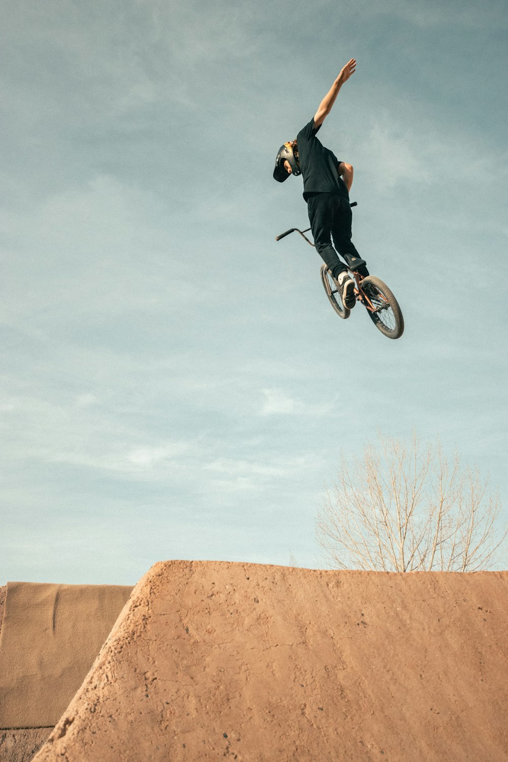 man in black jacket riding on bicycle during daytime