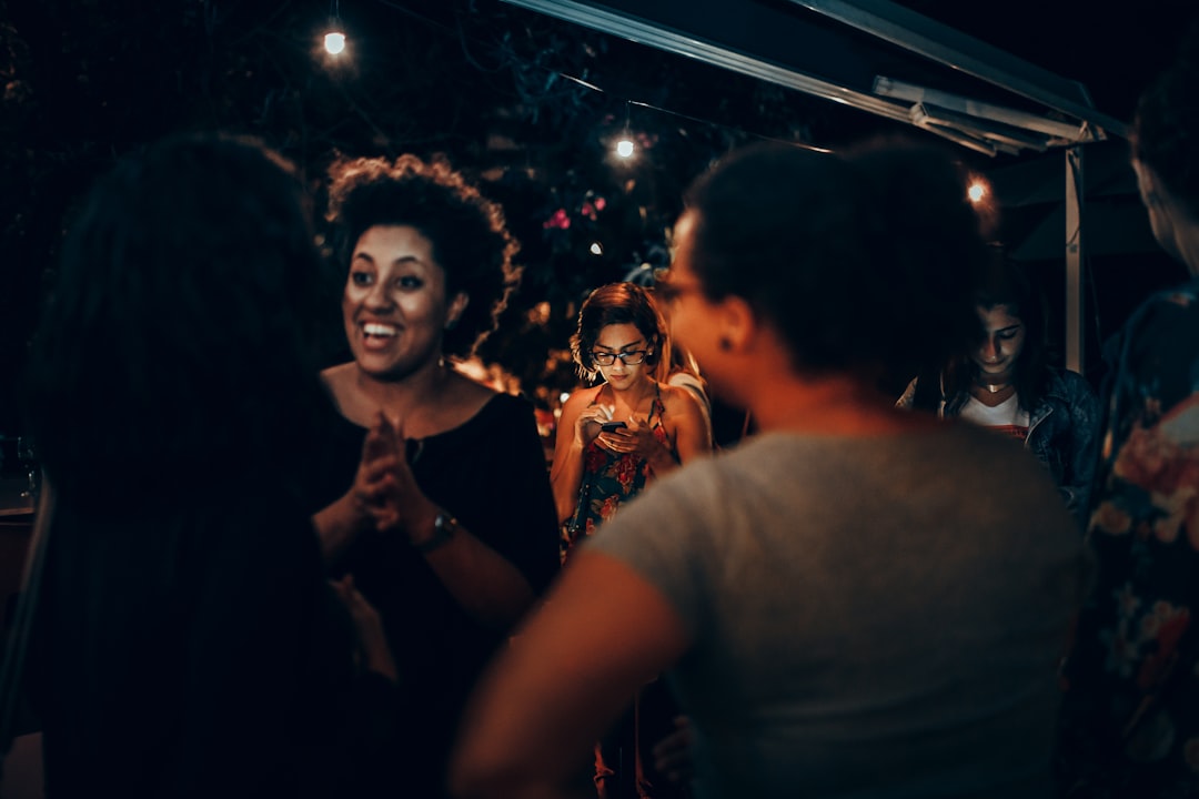 woman in white shirt standing beside woman in black shirt