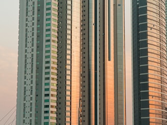a group of tall buildings next to a body of water