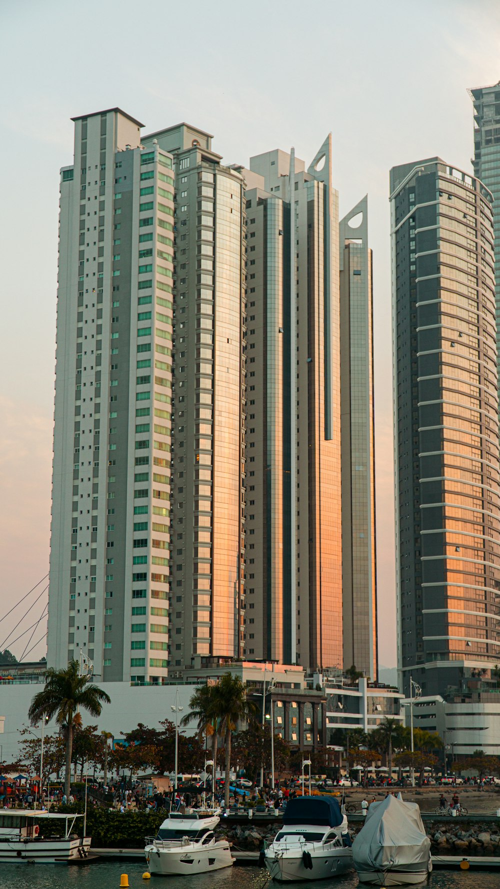 a group of tall buildings next to a body of water