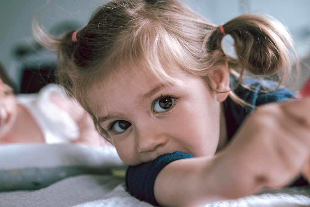 ragazza in canotta blu sdraiata sul letto