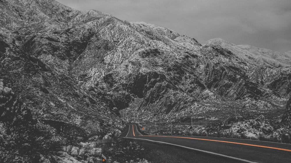 black asphalt road near gray mountain