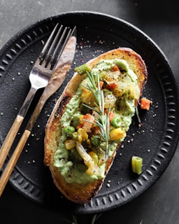 brown and green dish on black plate