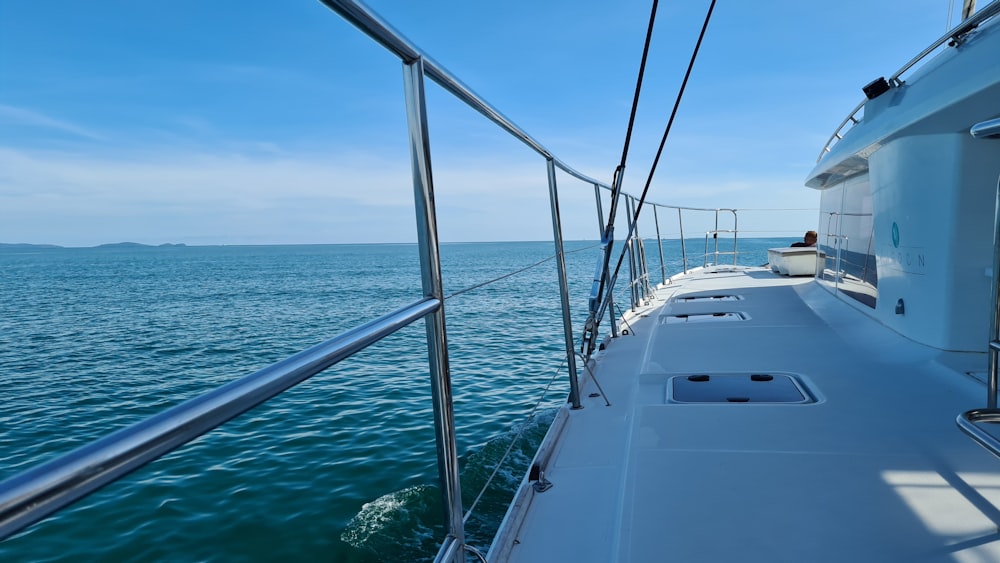 white yacht on sea under blue sky during daytime