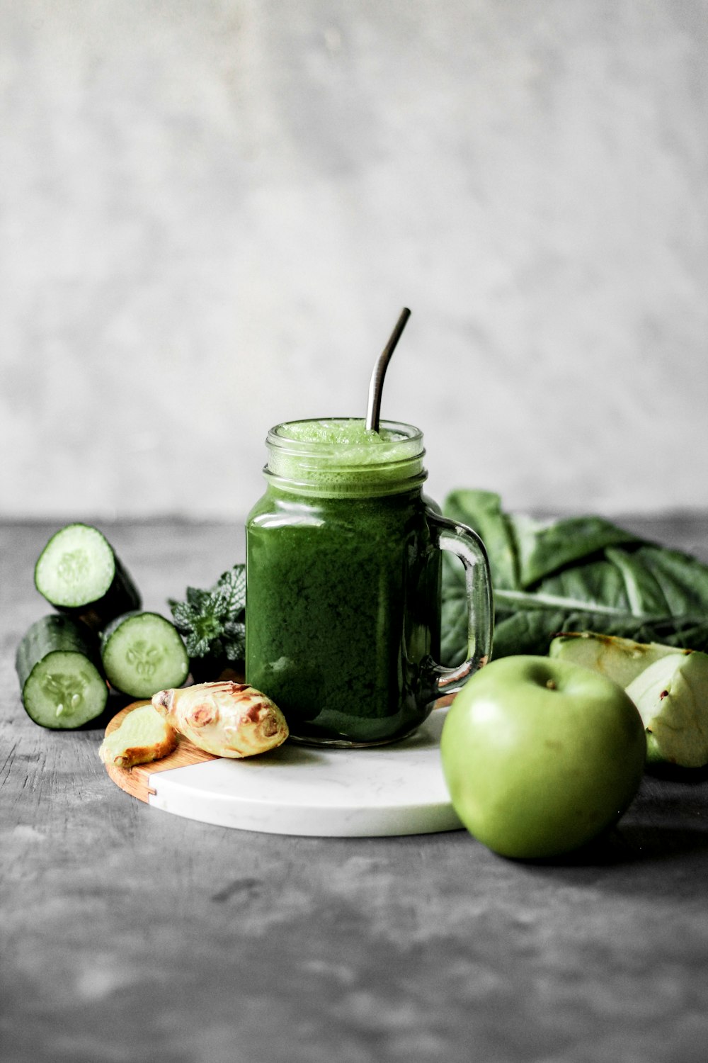 green apple fruit beside green ceramic mug on white ceramic plate