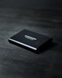 black power bank on black wooden table